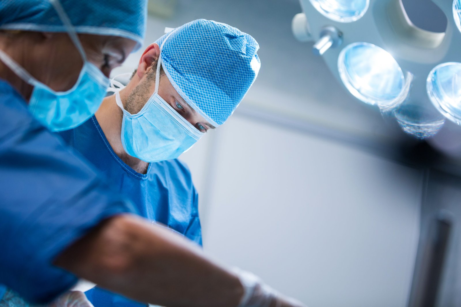 Surgeons performing operation in operation room